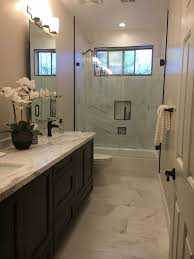 But bathrooms in most houses aren't so complicated. Bathroom Remodel Simple Elegance White Calcutta Umber Schluter Budget Bathroom Remodel Bathrooms Remodel Small Bathroom