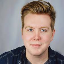 Meet Evan Leigh Rumler (he/him) as Carl from "Becoming Santa" Originally  from Central Illinois, Evan earned his degree in Musical Theatre from  Illinois Wesleyan University in Bloomington, IL. Some particularly  meaningful roles