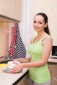 Young Wife Woman Washing Dishes In Kitchen Stock Photo, Picture And Royalty  Free Image. Image 69485386.