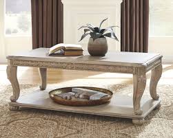 It makes the perfect perch for decorative serving trays or even board games for game nights with friends and family. Ashley Coffee Table