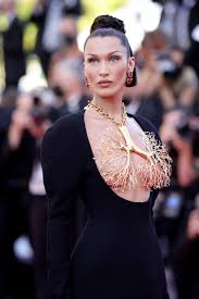 Jenner showcased her toned physique in a black plunging top. Cannes Film Festival 2021 Bella Hadid Wears A Mysterious Daring Schiaparelli Couture Dress On The Red Carpet Vogue Paris