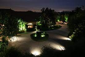 Parking Lighting Pathway Lighted With Bright Spot Lights Positioned Within Surrounding Garden Beds Walkway Lighting Outdoor Path Landscape Lighting