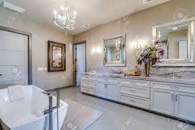 Chic master bathroom boasts oval freestanding tub and a brass vintage tub filler placed under a. Freestanding Tub And Walk In Open Shower Add Modern Trends To Stock Photo Picture And Royalty Free Image Image 151475850