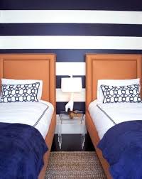 This madrid guest bedroom is a lesson in mixing patterns, thanks to its striped wallpaper by ralph lauren home, a daybed upholstered in a jim thompson toile de jouy, and graphic black and white flooring. Crisp Navy Blue And White Wall Stripes Coastal Decor Ideas Interior Design Diy Shopping
