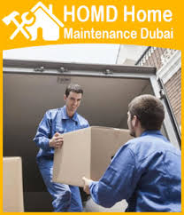 Full length of young male movers carrying sofa outside truck on street. Packers And Movers Dubai 0527692802 Home Maintenance Dubai