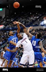 Connecticut's Phillip Nolan (1) fights for a rebound with Central  Connecticut State's Greg Andrade, left, and Corey Barrett during the first  half of an NCAA college basketball game in Hartford, Conn., on