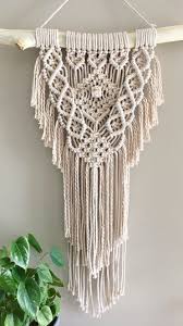 With the right color combinations, this is a gorgeous wall hanging guaranteed to elevate a room. Image Of Cleo Macrame Wall Hanging On Tas Oak Dowel Mto Macrame Wall Hanging Patterns Macrame Patterns Macrame Wall Hanger