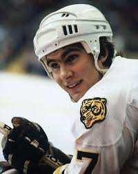 Boston Bruins rookie defenseman Ray Bourque smiles from the bench during a  game against the Edmonton Oilers