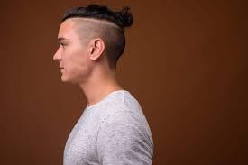 You can add variations to this hairstyle while your hair grows along time to medium length. 11 Suave Man Bun Hairstyles With Shaved Sides We Love