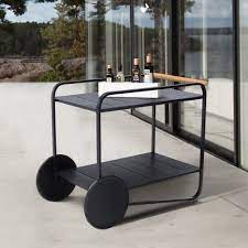 Stylish metal frame is finished in black and complemented by two solid wood shelves in a rustic oak finish. 17 Stories Jad Outdoor Bar Serving Cart Wayfair