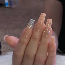 These coffin nails have a light ombre design with lots of rhinestones. Ballerina Nails Also Known As Coffin Shaped Nails Are Kylie Jenner S Signature Nail Shape Ballerina Na Peach Nails Pretty Acrylic Nails Coffin Nails Designs