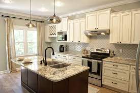 Granite in countertops for kitchens has become very popular granite comes in lots of different natural colors that you can think of, with the most popular being beige and brown. Our Kitchen After Off White Cabinets Amarone Granite Countertops Arabesque Backslash Tile Contrastin Faux Wood Tiles Kitchen Cabinets Decor Kitchen Design