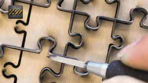 The original wood puzzles were cut with jigsaws, also known as scroll saws, and customized wooden puzzles are still made that way today. How Jigsaw Puzzles Are Made