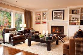 This pine coffee table works well with the burgundy brown tones in the floor and the mantel. How To Mix Wood Furniture Finishes