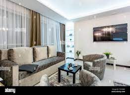 MINSK, BELARUS - January, 2019: luxure hall interior loft flat apartments  with tv sofa and armchairs Stock Photo - Alamy