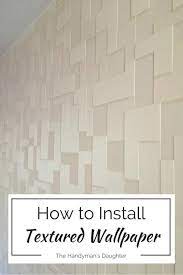 The brick accent wall is painted in white but retains plenty of characteristic texture. Textured Wallpaper Accent Wall Master Bedroom Update The Handyman S Daughter