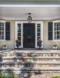 Covered Front Porch Cream Siding Black Front Door Shutters Stone Steps Black Planters Stone Porches Front Porch Stone Front Porch Steps