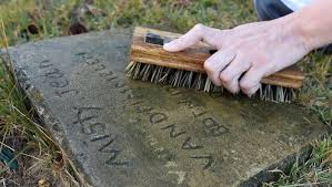 Female inmates help clean headstones at Galatia Cemetery