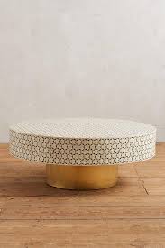 This wood top contrasts perfectly with the white patterned base, making a piece that adds a bit of something unique to your living room. Targua White Tiled Brass Coffee Table