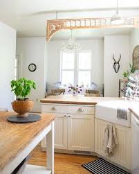 Dark wood floors and a white kitchen island with marble countertops create a rich and relaxing experience. 15 Cottage Country Kitchen Decor Ideas