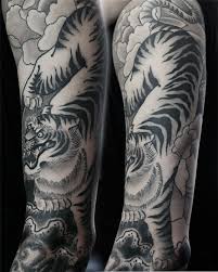 Tiger tattoos are the classic of all big cat tattoos and are a tattoo image that will never lose its power and presence, even these blackwork tiger tattoos are both beautiful and impressive and are sure to make you want some of your own blackwork body art!! 66 Black And Grey Tiger Tattoos Collection