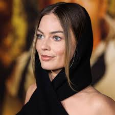 Margot Robbie Rocks Fiery Red-Hot Miniskirt And Matching Turtleneck Sweater  During BBC Radio Interview