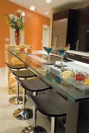 Classic kitchen boasts double breakfast island and a round dining table surrounded with green chairs in the corner and by the glass windows. Kitchen Bar Top Ideas How To Choose The Right Bar Counter