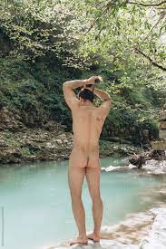 Naked Man Preparing To Swim In River by Stocksy Contributor Alina  Hvostikova - Stocksy
