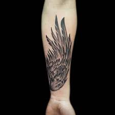 A celtic cross sits at the center of the upper back with finely inked realistic feather wings spread out on both sides. 128 Amazing Wing Tattoos To Adorn Your Skin Wild Tattoo Art
