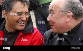 Zakie Achmat, left, head of Action Treatment Campaign and Dean Rowan Smith,  right, share a joke during a protest demonstration at the University of  Cape Town, South Africa, Wednesday, Aug. 15, 2007.