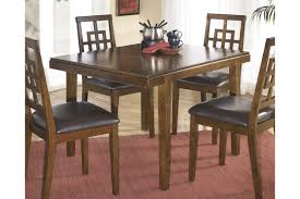 Wood dining room table sets are hefty and durable, however, ensure that your tabletop is sealed so moisture and liquid does not damage the precious wood. Cimeran Dining Table And Chairs Set Of 5 Ashley Furniture Homestore