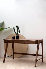 The nicely shaped top is inlaid with brown leather. Yackt Three Drawer Walnut Konk Custom Handmade Furniture