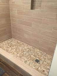 You can also match a backsplash on the bathroom vanity to the tile in your shower. Sliced Java Tan Pebble Tile Shower Floor 2 Bathroom Remodel Shower Pebble Tile Shower Pebble Tile Shower Floor