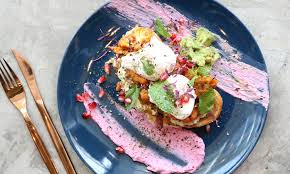 Pour a mixture of beaten eggs, milk, and shredded cheddar cheese into the pan and top with a decorative arrangement of sliced tomatoes before baking. Dubai S 31 Tastiest Vegetarian Dishes Restaurants Time Out Dubai