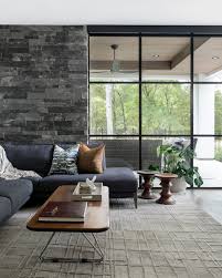 Windows of all shapes and sizes are amazingly energy efficient. Laura U Design Collective Floor To Ceiling Windows Provide An Unobstructed View Through This Clean Lined Seating Area To The Nature Enriched Exterior But The Real Stunner Is Within A Gray Stone Wall That