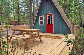Our beautiful lodge cabin is a one room air conditioned cabin with a queen bed, a futon that folds into full bed, carpeted loft accessed by staircase with two full mattresses, full bathroom, and kitchen. Nj Camping Cabins Rental Cabins New Jersey Camping