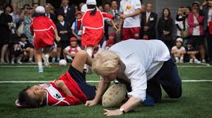 Boris Johnson Knocks Child To Ground In Touch Rugby Bbc News Mr johnson, dressed in a shirt and tie, ended up on the ground next to the youngster, who was pictured wincing in pain.
