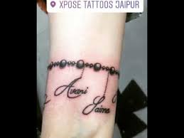Black christian cross tattoo on wrist. Rosary Tattoo With Names On Wrist Tattoo Xpose Tattoos Jaipur Youtube