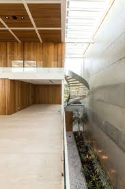 Stepping Inside This Modern House There S An Open Hallway With A View Of The Stairs That Lead To The Upper Floor Architecture Modern Family House House Design