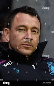 Aston Villa assistant head coach John Terry shares a joke with Liverpool  manager Jurgen Klopp before the Premier League match at Anfield, Liverpool.  Picture date: Saturday April 10, 2021 Stock Photo