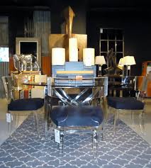 Horatio Dining Table With Acrylic Saturn Chairs Senufo Bird In Background Karwar Rug And Our Candle Collection Chair Candle Collection Dining Table