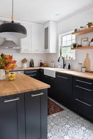 Modern Kitchen With Deep Walnut Open Shelves Natural Wood Bar Stools And White Waterfall Edged Countertops Greyk Modern Kitchen Kitchen Design Kitchen Places