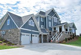 Situate in orange county, california, this house has many attractive features like reclaim wood siding, unusual window shapes, and a hedge fence. Contemporary Farmhouse Eldorado Stone