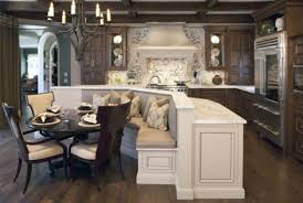 A custom kitchen featuring an island that offers a breakfast bar counter with seats set on the hardwood flooring. 10 Must See Kitchen Islands With Seating Lovely Spaces