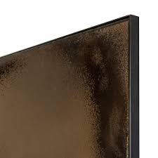 Two solid iron branches cross in the center of this wall art. Bronze Wall Mirror