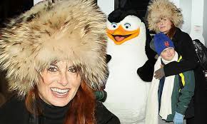 Debra Messing wears incredible headgear to ice-skate at the Penguins Of  Madagascar premiere