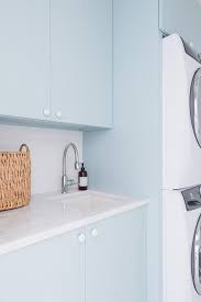 It gives a fresh and clean vibe from your. Light Blue Flat Front Laundry Cabinets With White Knobs Transitional Laundry Room