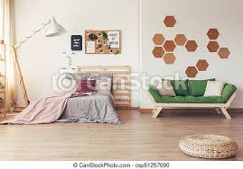 A multifunctional wooden 'bedroom box' creates a whole new room and storage area for this tiny apartment! Multifunctional Bedroom With Cork Board Braided Pouf In Front Of Green Wooden Sofa In Multifunctional Bedroom With Cork Canstock