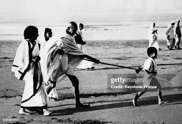 Mahatma GANDHI having fun with one of his grand-children on a Juhu... News Photo - Getty Images
