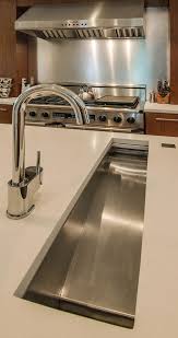 A new refrigerator framed by pantry cabinets consolidates food storage. Old Dog New Tricks Kitchen Inspirations Kitchen Countertops New Kitchen Designs